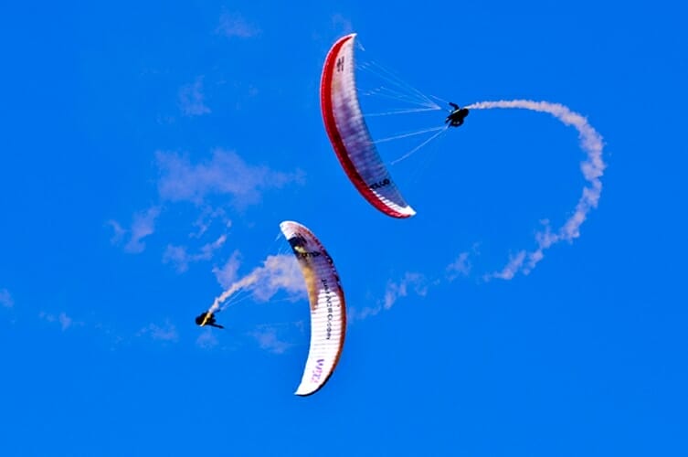 paragliding doing tricks with smoke